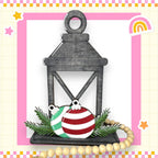 a card with a lantern and ornaments on it