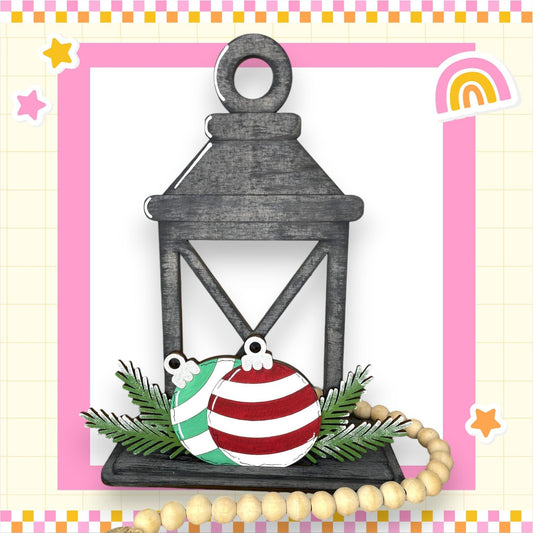 a card with a lantern and ornaments on it