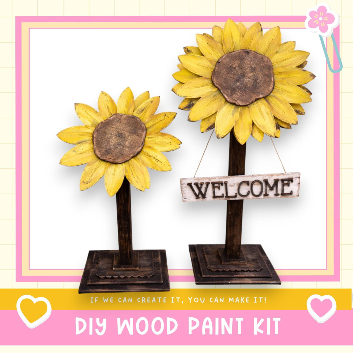 two wooden sunflower sculptures, each with a wooden sign attached to them. The sign reads "WELCOME". The sculptures are placed on a wooden stand, and the background is a pink and white checkered pattern. The image also includes text that says "DIY WOOD PAINT KIT" and "If we can create it, you can make it!"