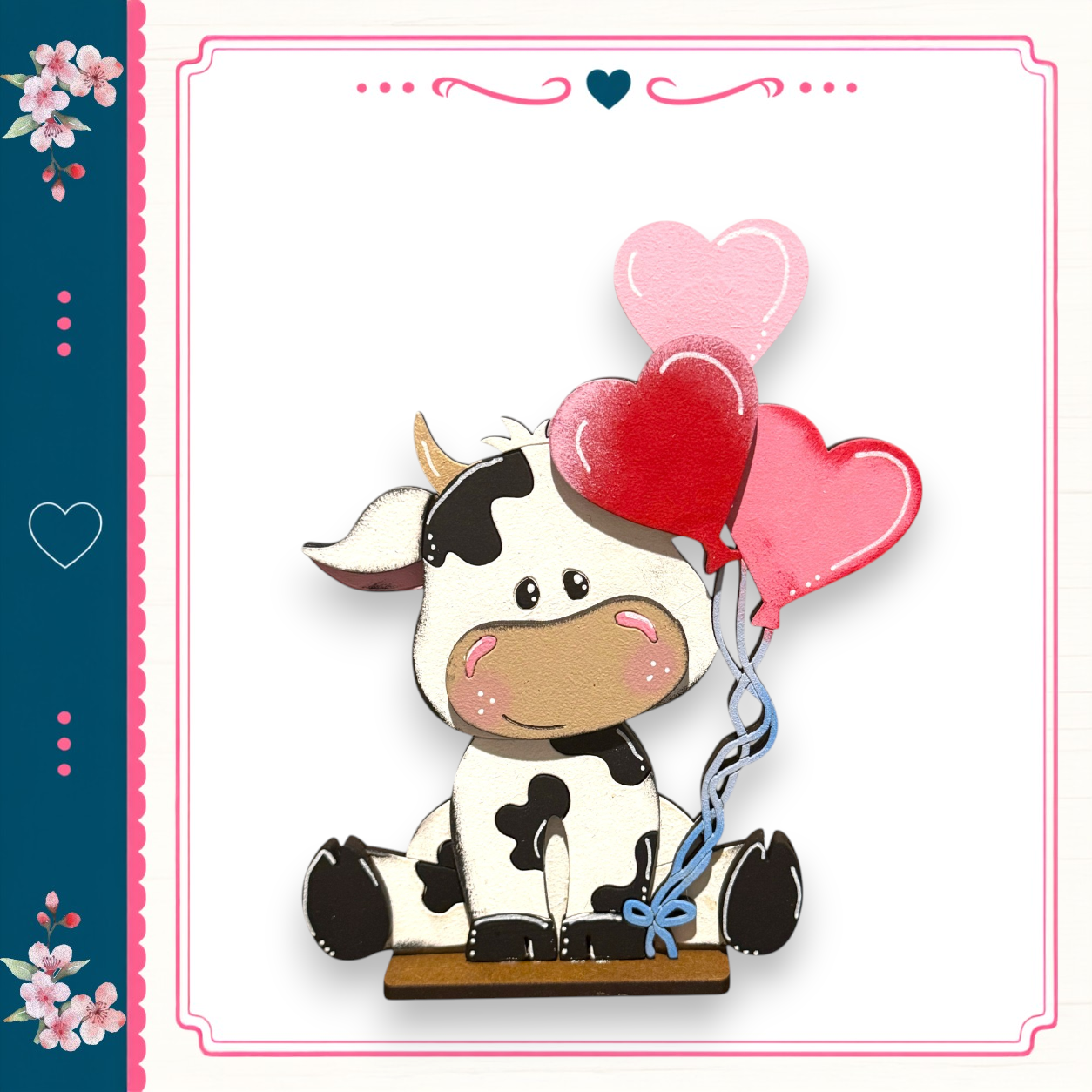 A cartoon cow holding three heart-shaped balloons in its mouth, sitting on a wooden surface.