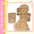 a skeleton figure holding a pumpkin, which appears to be part of a Halloween-themed kit.