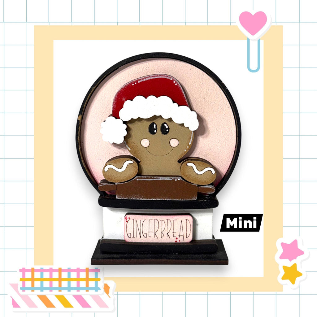 A gingerbread man wearing a Santa hat and holding a sign that says "Gingerbread" is the main focus of the image.
