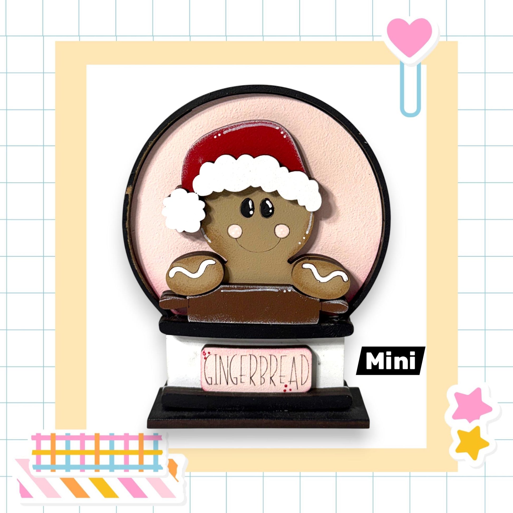 A gingerbread man wearing a Santa hat and holding a sign that says "Gingerbread" is the main focus of the image.