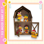 A wooden barn-shaped display case containing four small figurines, each wearing a festive hat and scarf, with one of the figures holding a wreath.
