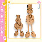 two wooden figures, likely made of cardboard, wearing top hats and standing on platforms.