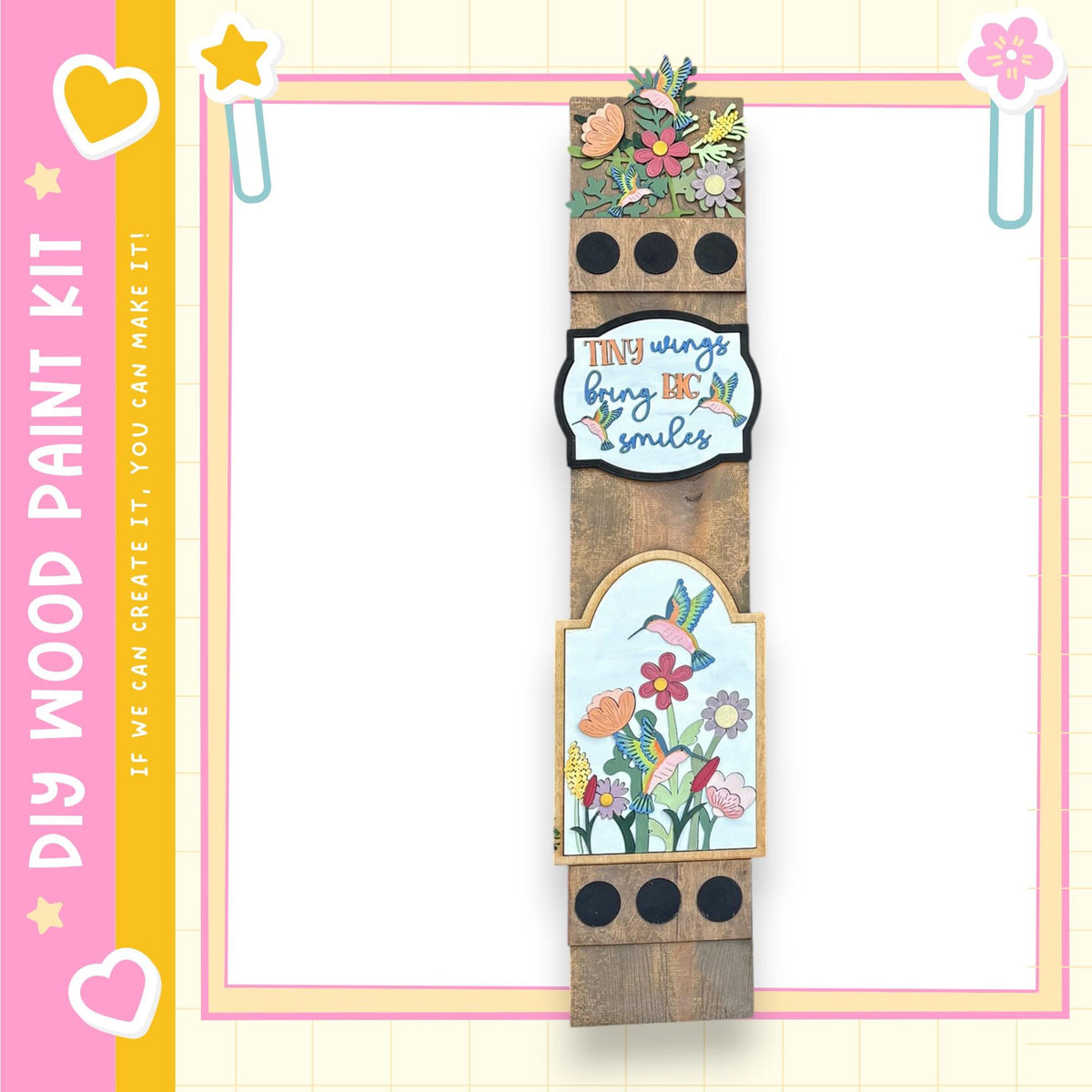 The image is a colorful and decorative wooden frame with various floral and bird-themed elements, including a heart, flowers, and a bird. The frame appears to be a creative and artistic piece, possibly used for scrapbooking or as a decorative item.