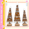 three gingerbread trees, each with unique designs and decorations, arranged in a row against a white background.