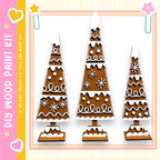 three gingerbread trees, each with unique designs and decorations, arranged in a row against a white background.