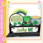 a DIY paint kit for creating a Lucky Me sign, which includes Irish kissing, a pot of gold coins, and a leprechaun hat.