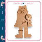 A cardboard cutout of a girl wearing glasses and holding a lollipop, with a heart-shaped design on the left side of the image.