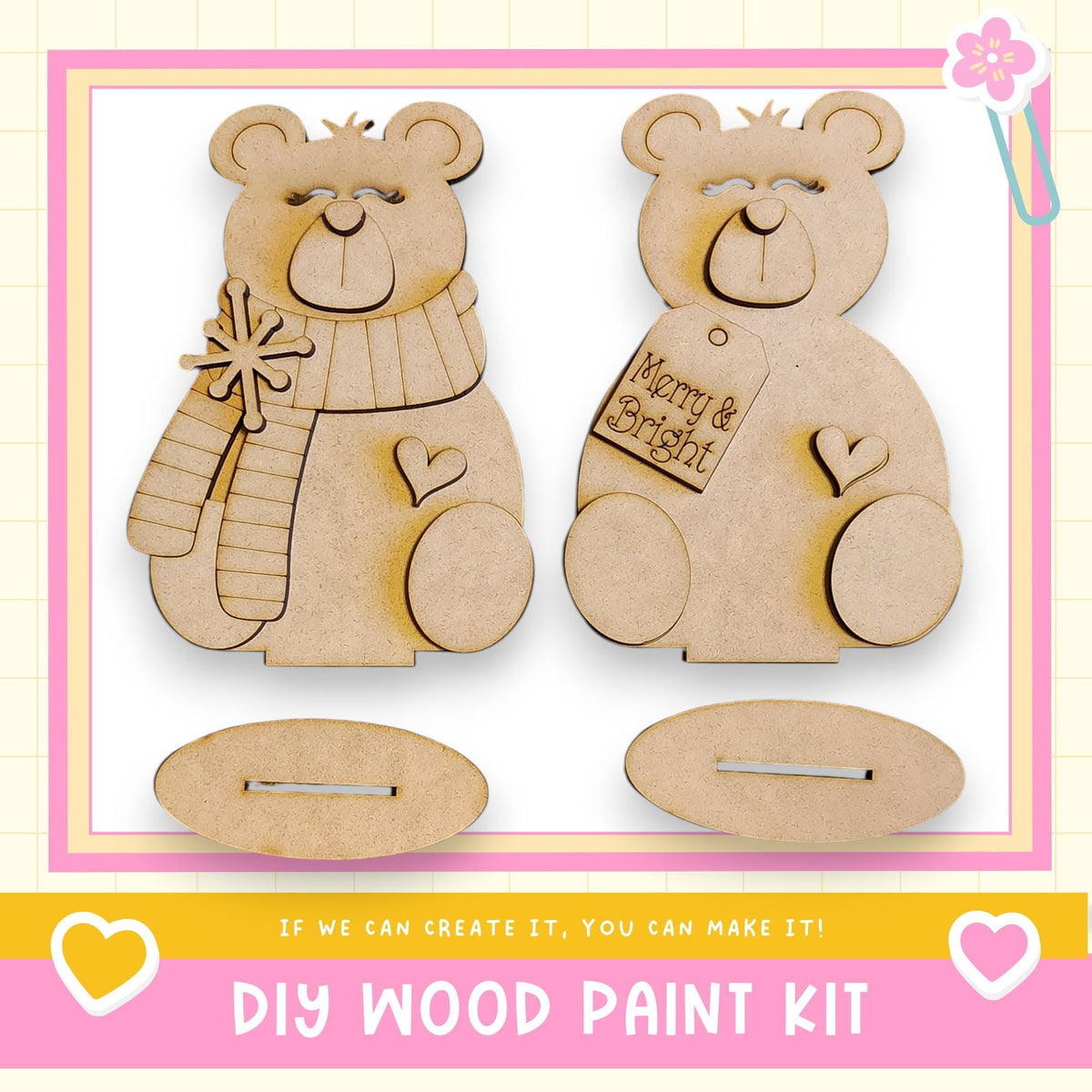 two wooden teddy bear ornaments, each with a tag that says "Merry & Bright". The ornaments are displayed against a pink and yellow background, and there is text at the bottom of the image that reads "DIY WOOD PAINT KIT" and "If we can create it, you can make it!".