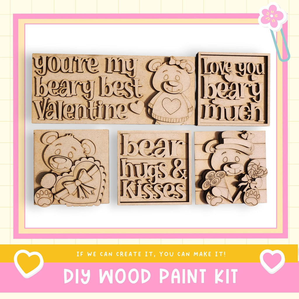 The image is a promotional image for a DIY wood paint kit, featuring various wooden shapes and designs, including a bear and a heart.