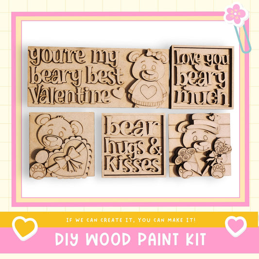 The image is a promotional image for a DIY wood paint kit, featuring various wooden shapes and designs, including a bear and a heart.