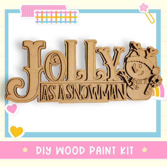 a DIY wood paint kit for creating a wooden sign with the word "Jolly" and a snowman figure.