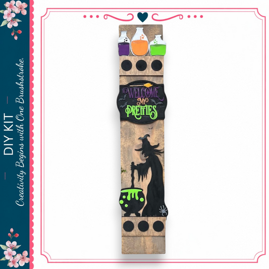 A wooden sign with a witch illustration and the text "Welcome to the pretty witch" displayed on it.