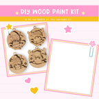 The image is a DIY wood paint kit featuring four wooden ornaments with various designs, including a snowman, a cat, and a bird. The kit appears to be a creative project that allows users to customize their ornaments with different designs and patterns.