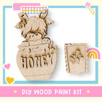 a wooden cutout of a cow with a honey jar