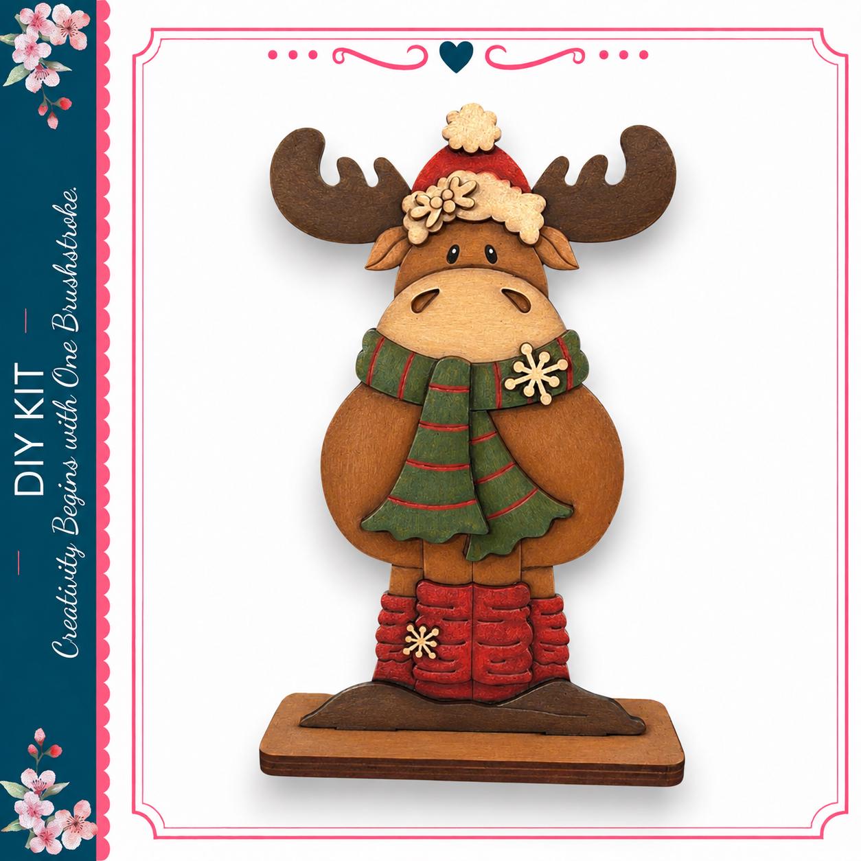 A wooden moose figurine wearing a green scarf and red boots, standing on a wooden base.