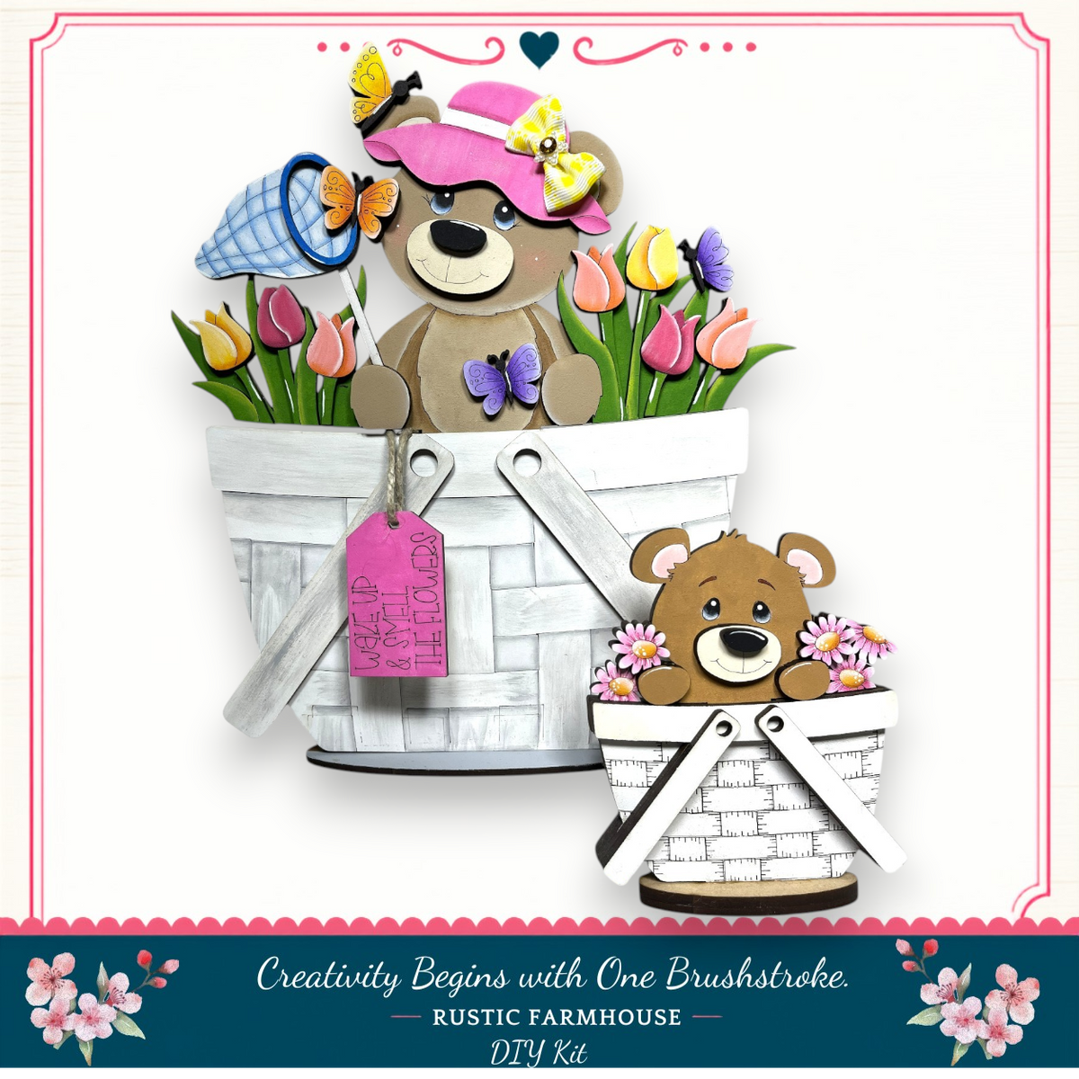 A wooden basket with a teddy bear and a small brown bear sitting inside, surrounded by flowers.