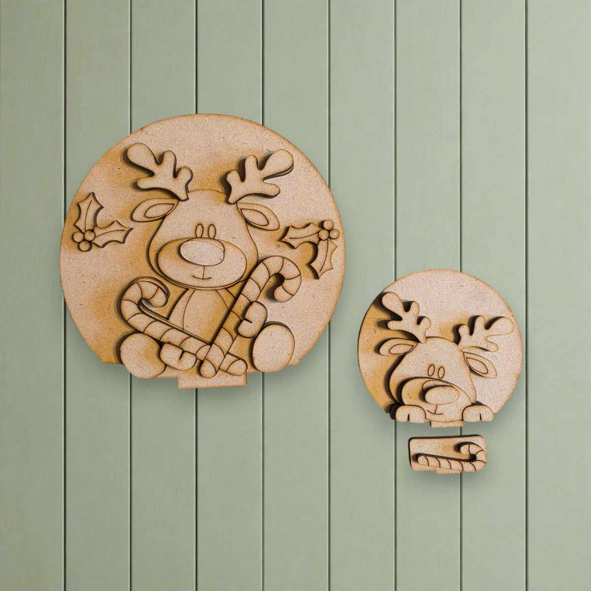 two wooden cutouts of reindeer, one larger and one smaller, both holding candy canes and holly leaves.