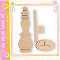 a DIY paint kit with a wooden figure and a wooden stick, all of which appear to be made of cardboard.