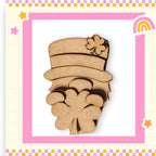 a wooden cutout of a lepreite with a rainbow in the background