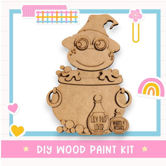 a DIY wood paint kit with a cute cartoon character made of wood, including a cauldron and various other wooden objects.