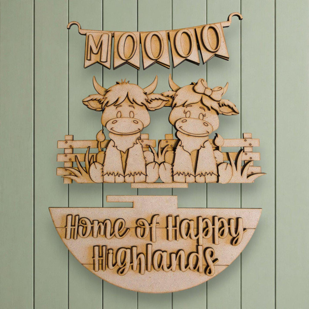 a wooden sign with a banner and two cartoon cow figures, along with the text "Home of Happy Highlands".