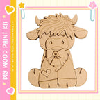 A wooden cutout of a cow with a bow tie, sitting on its hind legs.