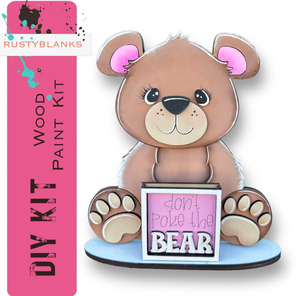 a brown teddy bear sitting on top of a sign