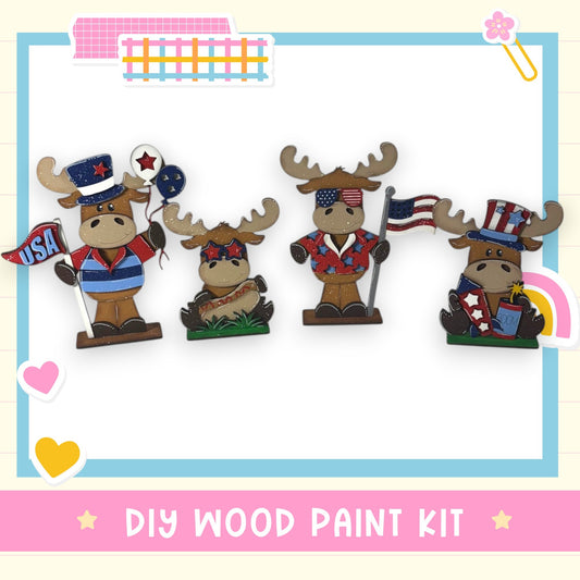 four cartoon moose figurines dressed in patriotic attire, including hats and flags, arranged in a row.