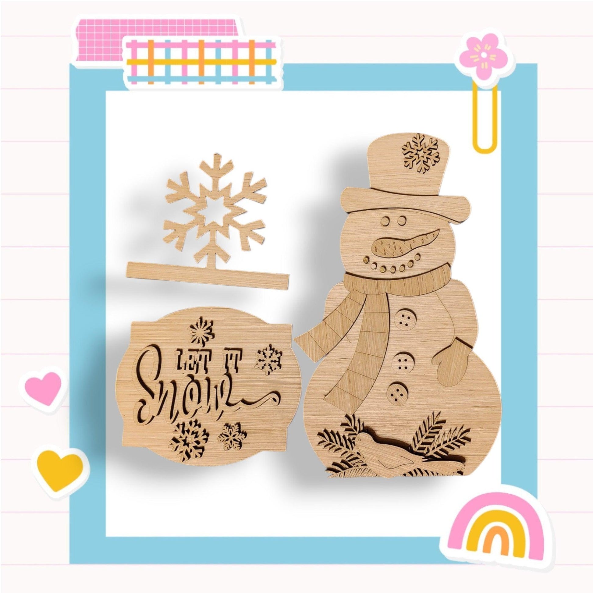 a wooden cutout of a snowman and a rainbow