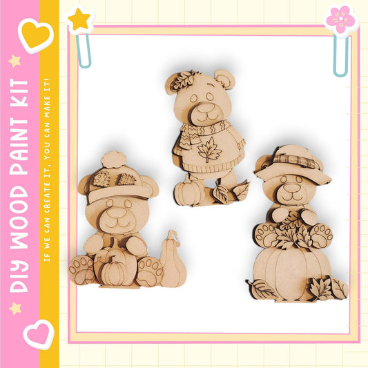 three wooden bear figurines, each with unique accessories such as a hat, scarf, and pumpkin.