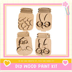 The image is a DIY wood paint kit featuring four wooden mason jars with various animal faces and designs carved into them.