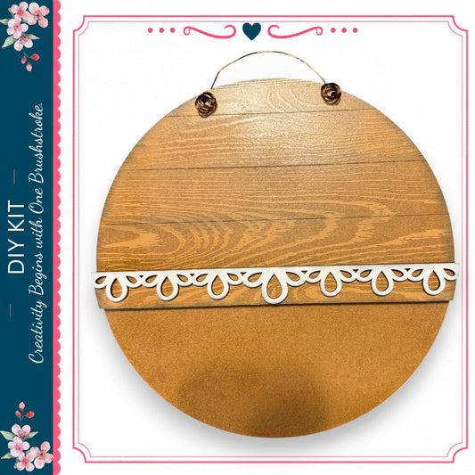 a wooden sign with a decorative lace border, hanging on a wall.