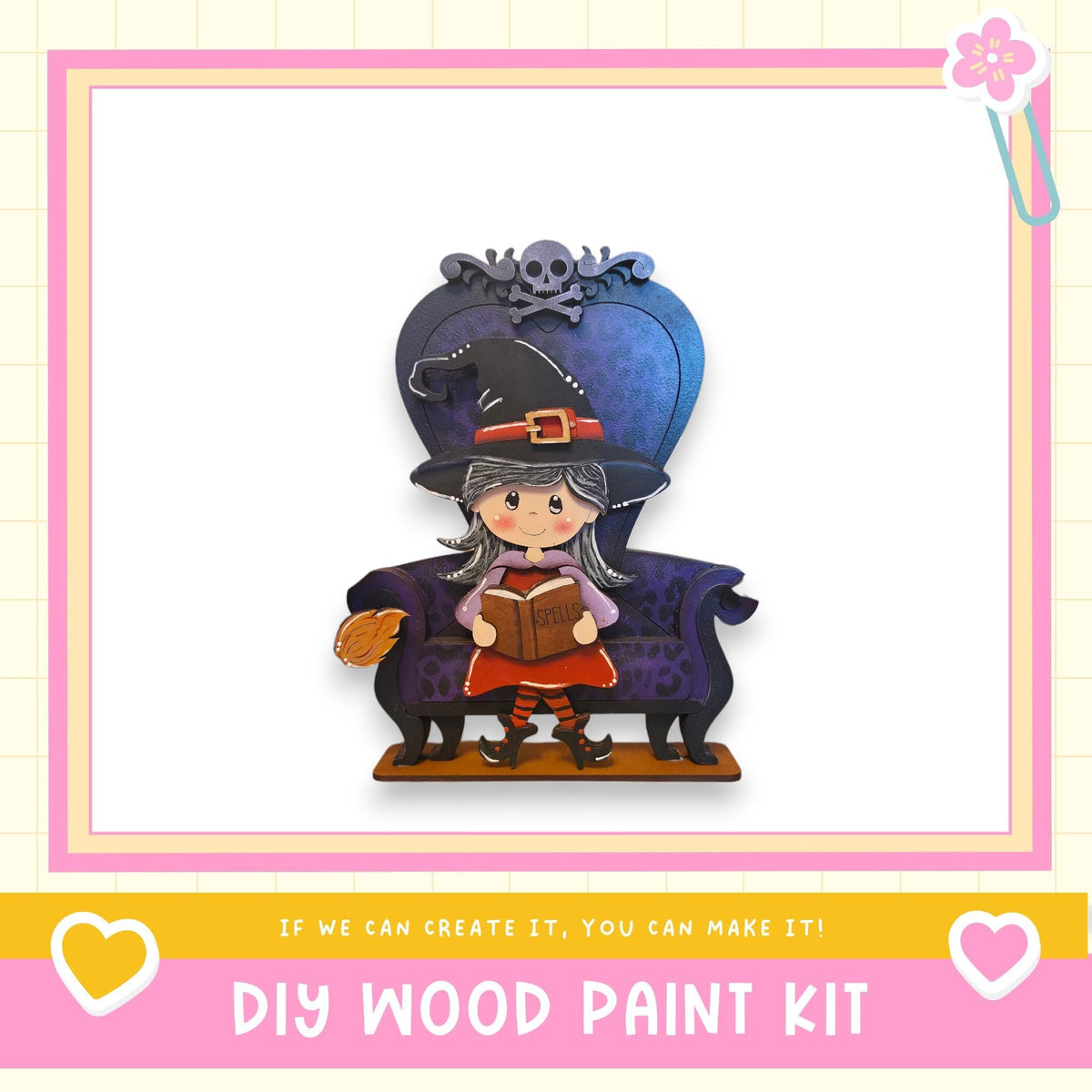 A wooden doll with a witch hat and a book in her hand, sitting on a purple chair.