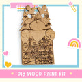 A DIY wood paint kit for creating a Christmas-themed sign, featuring a wooden reindeer and the text "Christmas cheer welcome here".