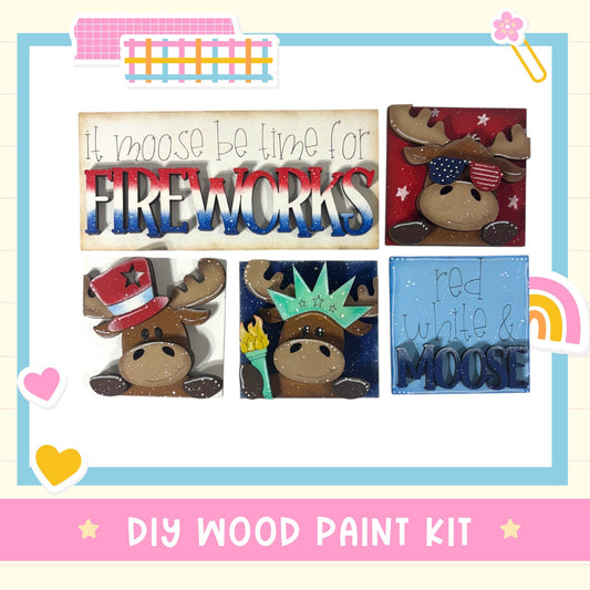 The image is a collage of four wooden paint kits featuring moose heads, with the text "It moose be time for fireworks" and "red white & moose" written on them.