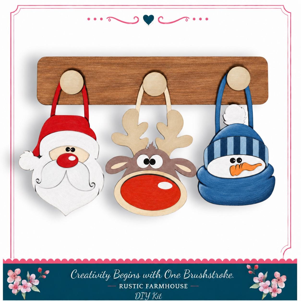A DIY kit featuring a wooden board with three wooden ornaments hanging on it, including a Santa Claus, a reindeer, and a snowman.