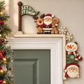 a festive holiday scene with a Christmas tree, Santa Claus, a gingerbread man, and a snowman. The decorations are arranged on a wall, creating a cheerful and seasonal atmosphere.