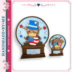 two snow globes, each containing a cartoon character wearing patriotic attire. The character in the larger snow globe is wearing a hat and holding an American flag, while the character in the smaller snow globe is wearing sunglasses and holding a moo. The snow globes are set against a blue background with stars and red and white stripes.