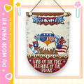 a wooden sign with patriotic decorations, including an eagle wearing sunglasses and holding an American flag. The sign is hanging on a wall and has a message that reads "Land of the free, because of the brave".