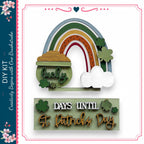 The image is a collage featuring a rainbow, a pot of gold, and shamrocks, along with a sign that says "DAYS UNTIL St. Patrick's Day".