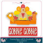 The image is a promotional image for a DIY turkey decoration kit. It features a colorful turkey figure with a pie and pumpkins, along with the text "GOBBLE GOBBLE" and "Creativity Begins with One Brushstroke - Rustic Farmhouse - DIY Kit".