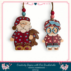 two wooden ornaments hanging from a string, depicting Santa Claus and a young girl.