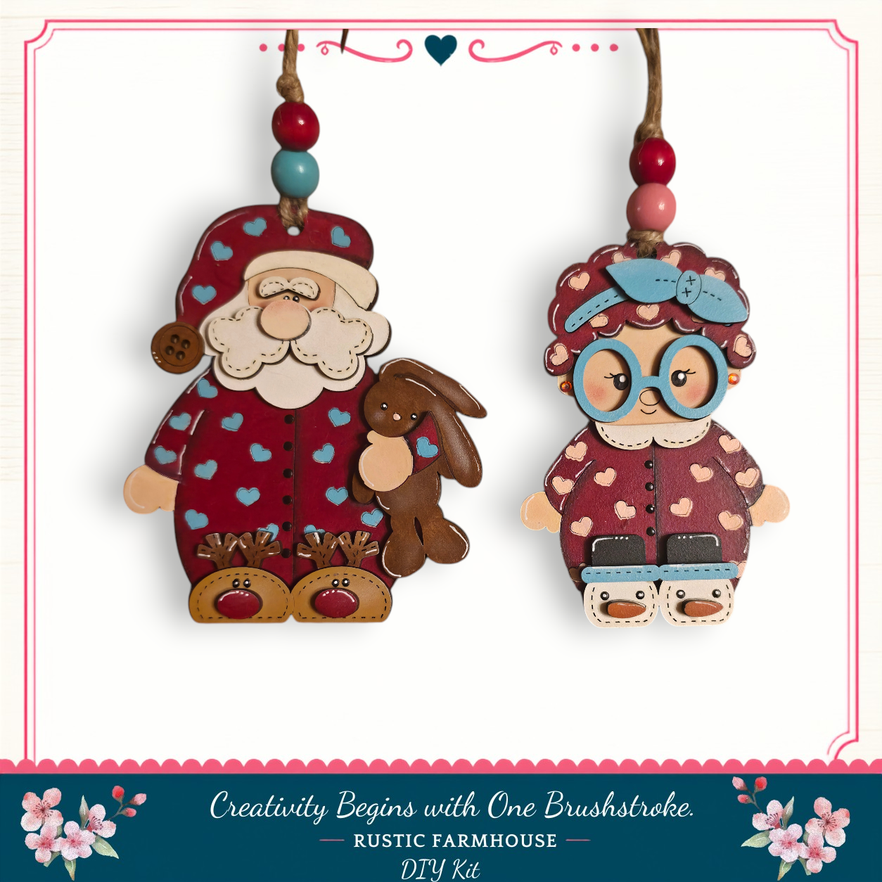 two wooden ornaments hanging from a string, depicting Santa Claus and a young girl.