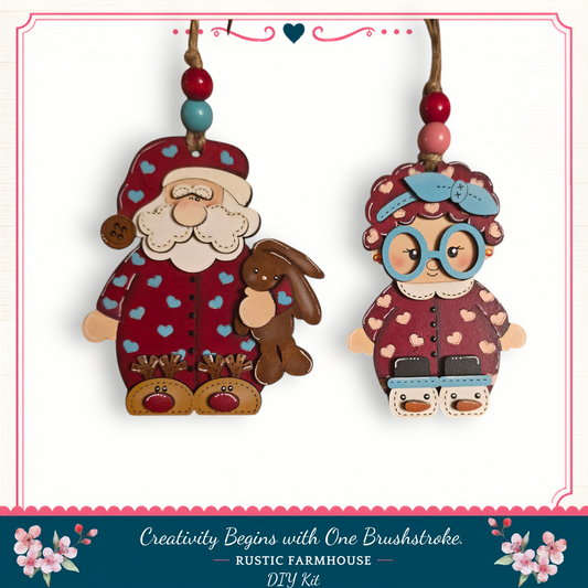 two wooden ornaments hanging from a string, depicting Santa Claus and a young girl.