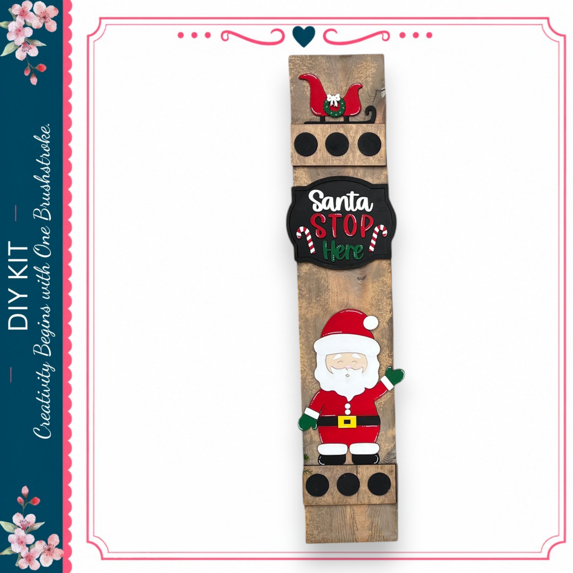 a wooden sign with a Santa Claus figure and the text "Santa STOP Here" displayed on it.
