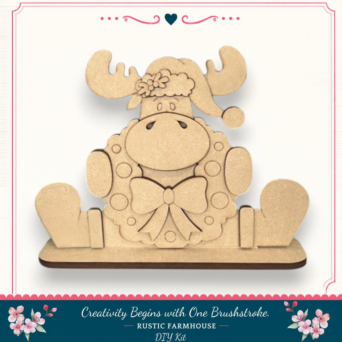 A wooden toy moose wearing a wreath and hat, sitting on a wooden base.