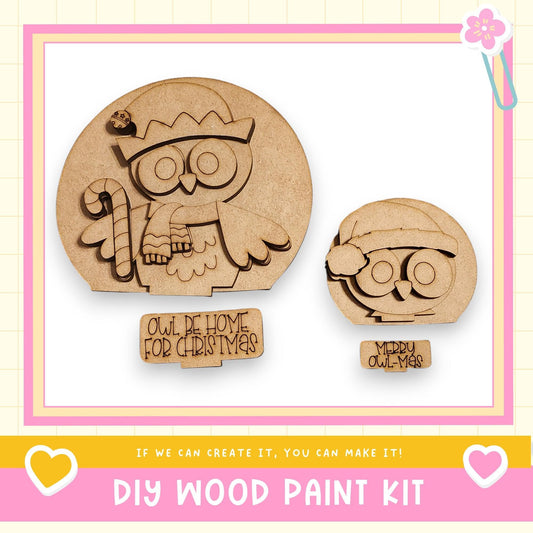 a DIY wood paint kit for creating wooden owls, with two owl-shaped cutouts and a sign that reads "Owl be home for Christmas".
